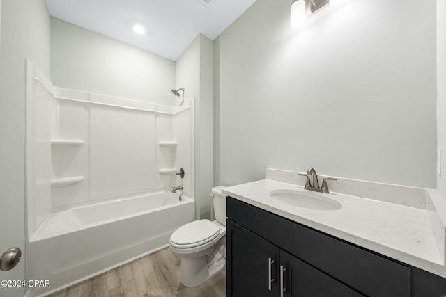 full bathroom featuring vanity, shower / tub combination, hardwood / wood-style flooring, and toilet