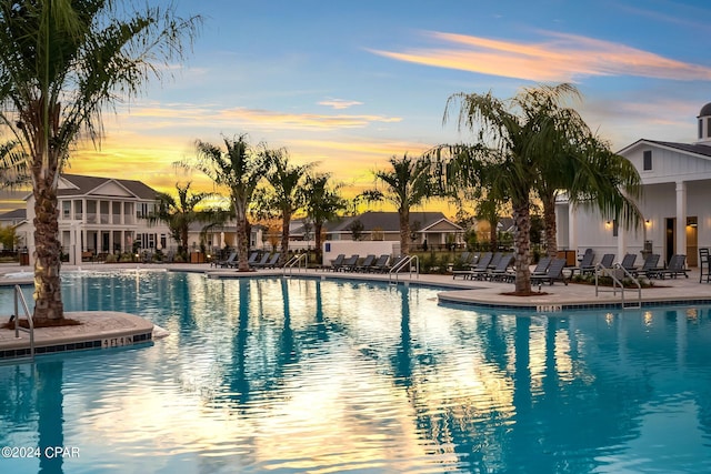 pool at dusk with a patio