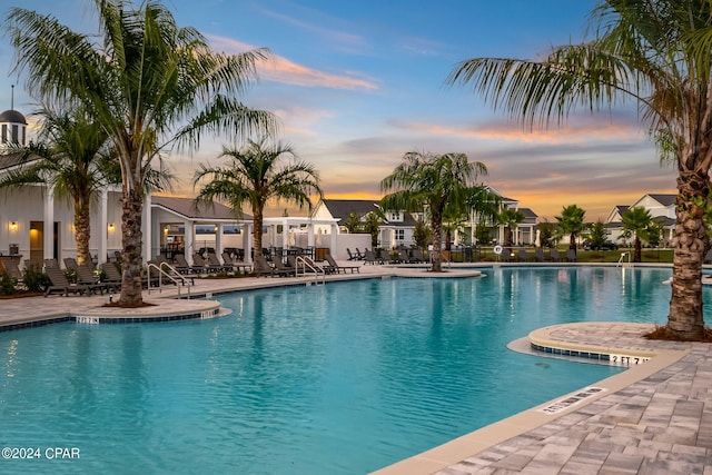 pool at dusk with a patio