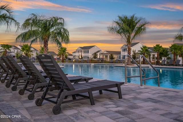 pool at dusk with a patio