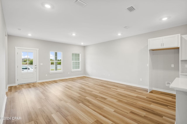 unfurnished living room featuring light wood-type flooring