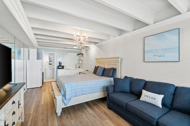 bedroom with a notable chandelier, light hardwood / wood-style flooring, connected bathroom, and beam ceiling