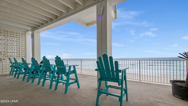 balcony featuring a water view and a beach view