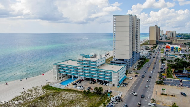 aerial view with a water view and a beach view