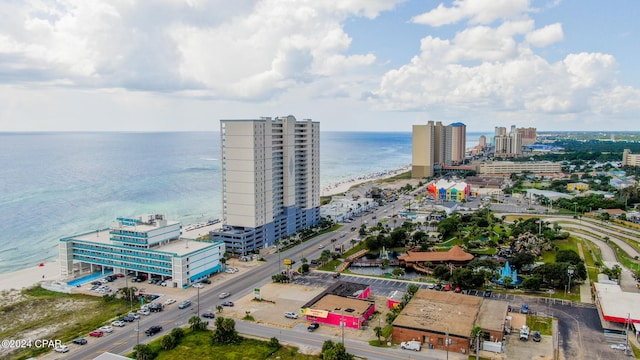 bird's eye view with a water view and a beach view