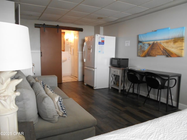 14401 Front Beach Rd Unit 433, Panama City Beach, FL 32413 - living room featuring a barn door, a drop ceiling, and wood finished floors