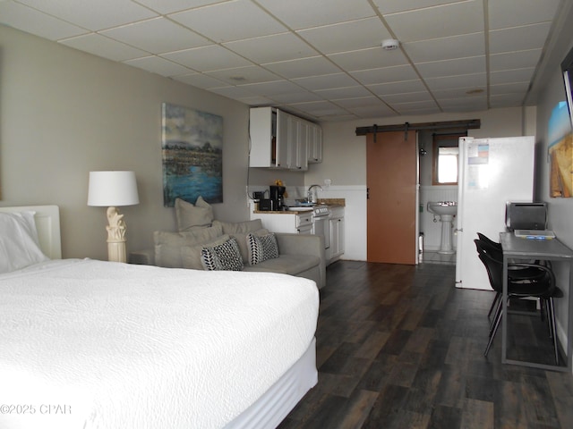 14401 Front Beach Rd Unit 433, Panama City Beach, FL 32413 - bedroom with a drop ceiling, a barn door, and dark wood-style flooring