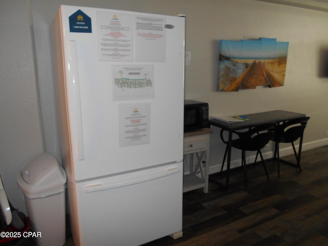 interior space featuring dark hardwood / wood-style flooring and white fridge