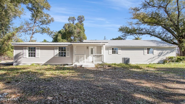 rear view of house featuring a porch