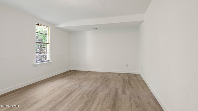 spare room featuring light hardwood / wood-style flooring