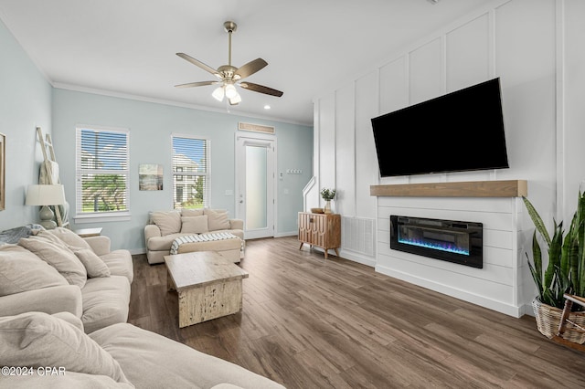 living room with ornamental molding, ceiling fan, and dark hardwood / wood-style flooring