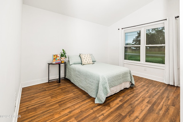 bedroom with dark hardwood / wood-style flooring and vaulted ceiling