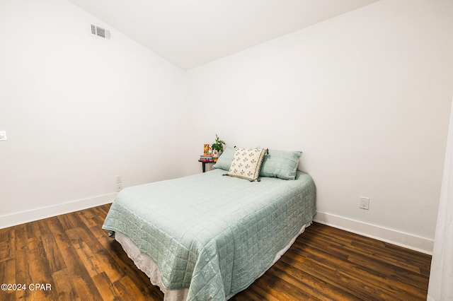 bedroom featuring vaulted ceiling and dark hardwood / wood-style flooring