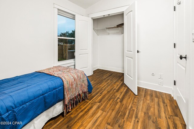 bedroom featuring dark wood-type flooring and a closet