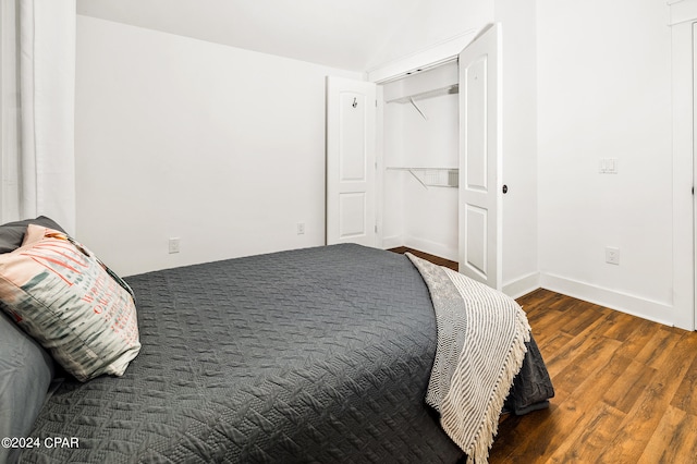 bedroom featuring a closet and dark hardwood / wood-style flooring