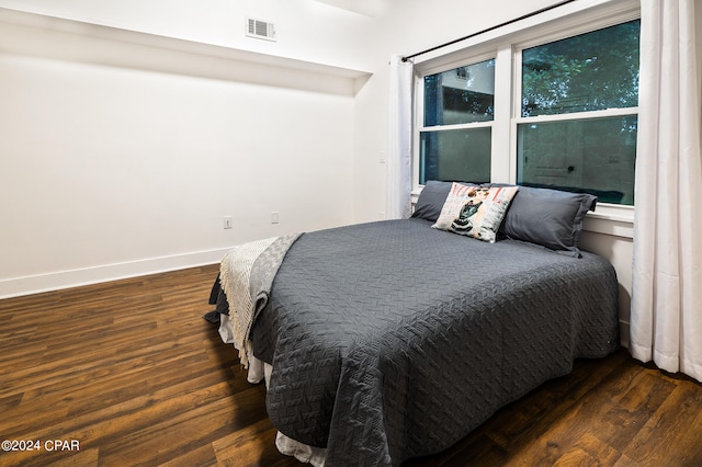 bedroom featuring dark hardwood / wood-style flooring