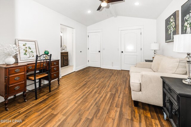 living room featuring dark hardwood / wood-style flooring, ceiling fan, and vaulted ceiling with beams