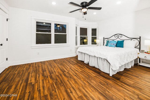 unfurnished bedroom with dark hardwood / wood-style flooring and ceiling fan