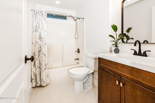 full bathroom featuring shower / bath combo with shower curtain, tile patterned flooring, vanity, and toilet