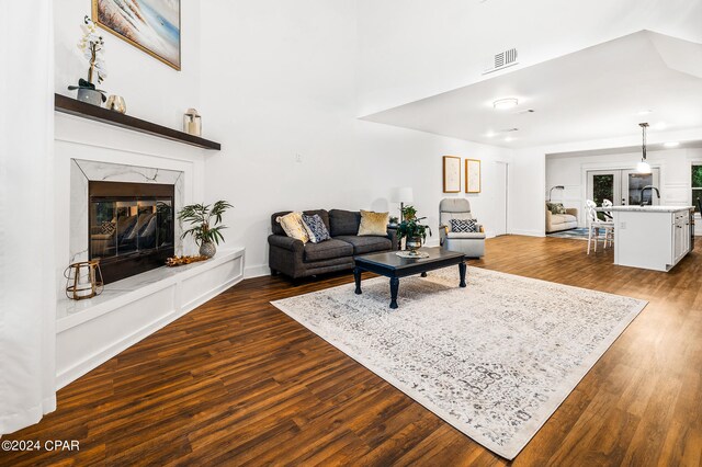 living room with dark hardwood / wood-style floors and a fireplace