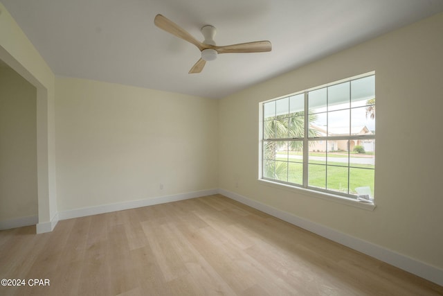 spare room with ceiling fan and light wood-type flooring