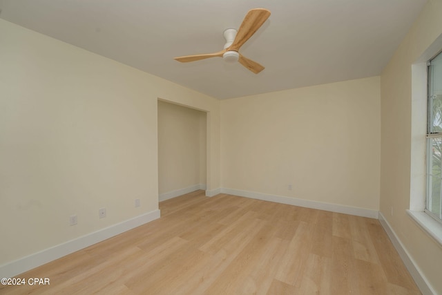 empty room featuring light wood-type flooring and ceiling fan