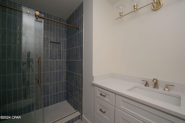 bathroom featuring vanity and an enclosed shower