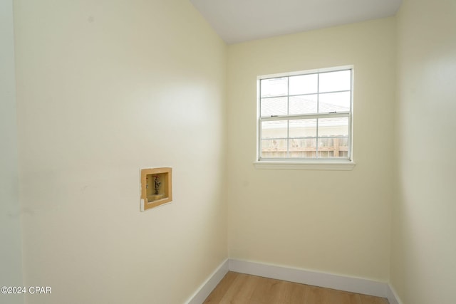 washroom with washer hookup and light hardwood / wood-style flooring