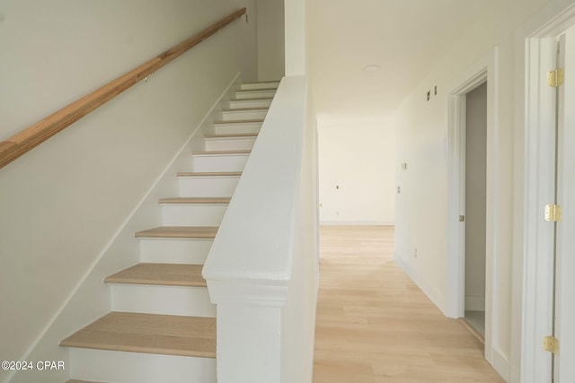 staircase featuring hardwood / wood-style flooring