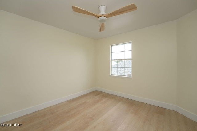 empty room with ceiling fan and light wood-type flooring