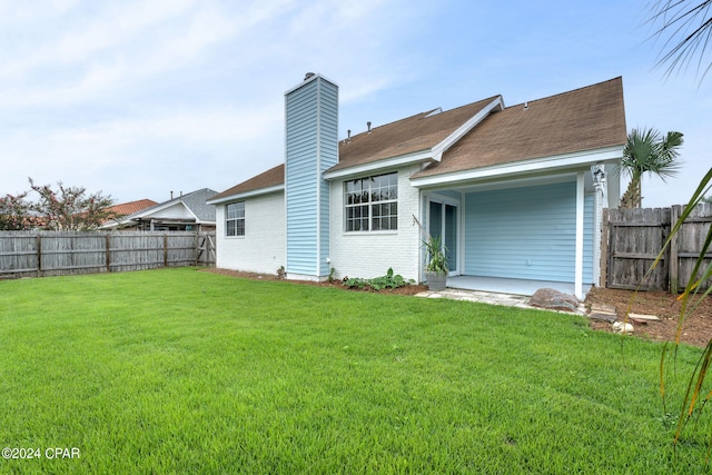 rear view of property with a patio area and a yard