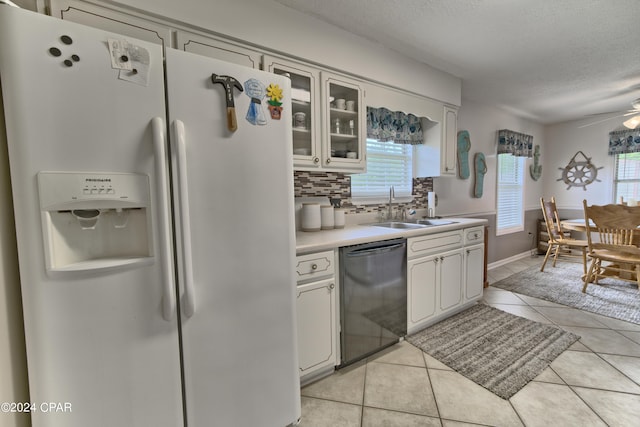 kitchen featuring sink, dishwasher, white cabinets, and white refrigerator with ice dispenser