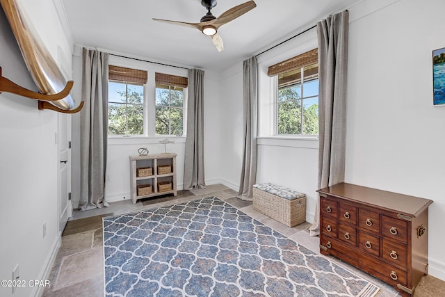 bedroom featuring ceiling fan and multiple windows