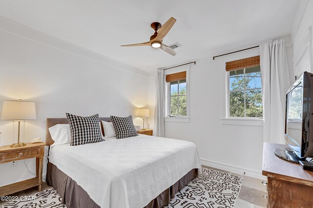 bedroom featuring ceiling fan and ornamental molding