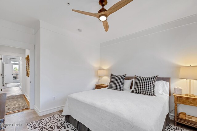 bedroom with ceiling fan and light hardwood / wood-style floors