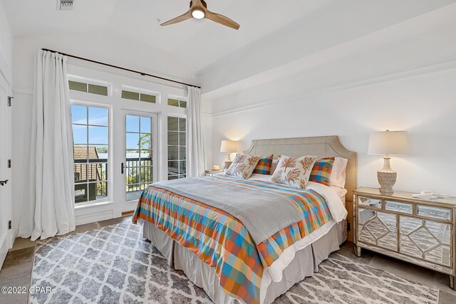 bedroom featuring vaulted ceiling, access to outside, hardwood / wood-style flooring, and ceiling fan