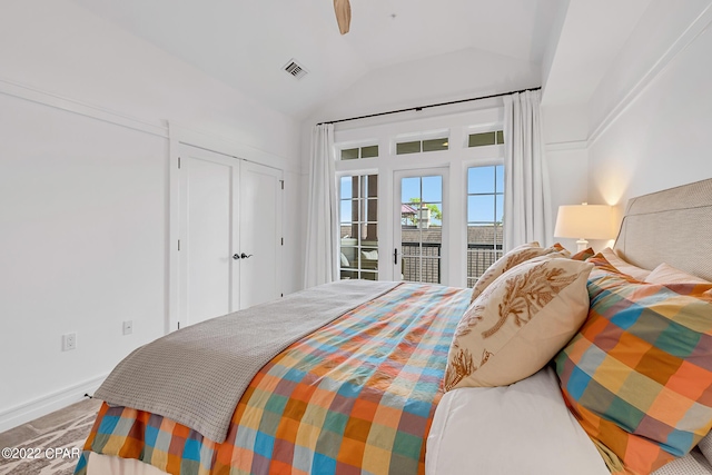 bedroom with access to outside and vaulted ceiling