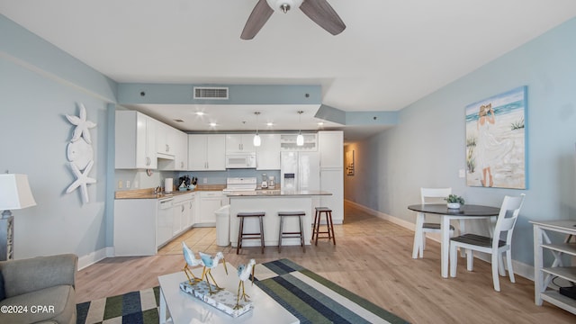 living room featuring light hardwood / wood-style flooring and ceiling fan