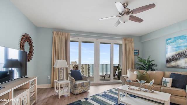 living room with ceiling fan and light wood-type flooring