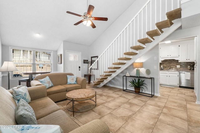 living room featuring high vaulted ceiling, ceiling fan, sink, and light tile patterned flooring