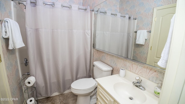 bathroom featuring tile patterned flooring, vanity, and toilet