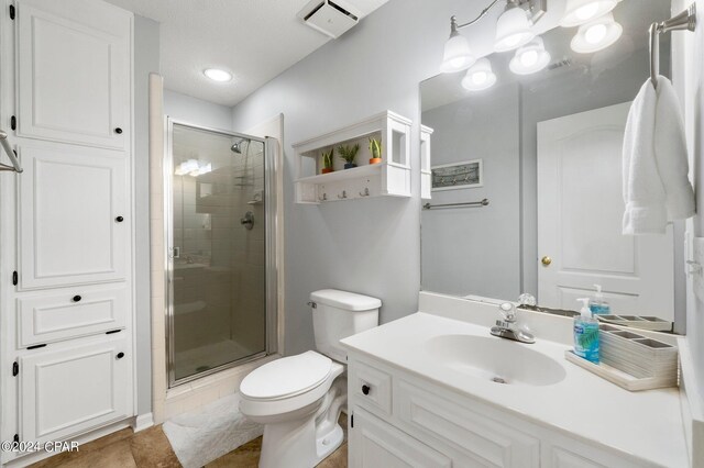 bathroom featuring vanity, toilet, and an enclosed shower