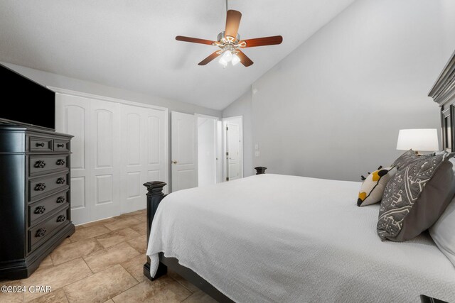 tiled bedroom featuring ceiling fan, a closet, and high vaulted ceiling