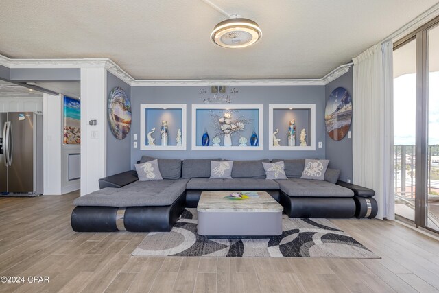 living room featuring crown molding, a textured ceiling, and hardwood / wood-style flooring