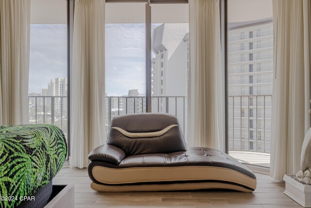 living area featuring expansive windows and light wood-type flooring