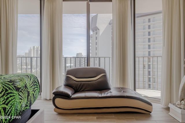 sitting room featuring a view of city and wood finished floors