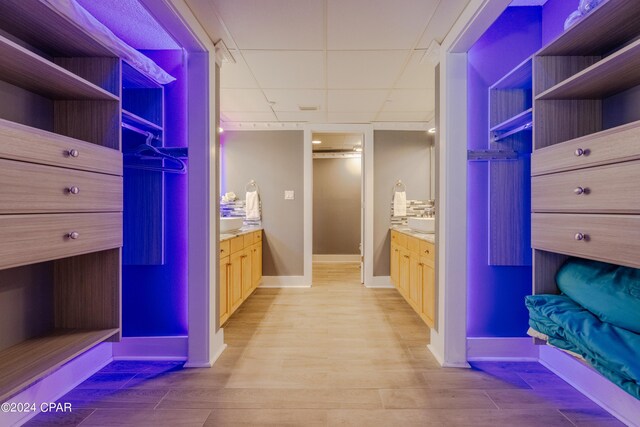 bathroom featuring vanity, wood-type flooring, and a drop ceiling