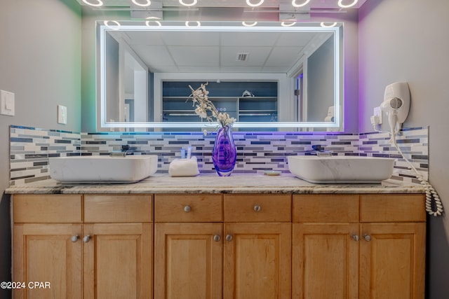 bathroom featuring tasteful backsplash and vanity