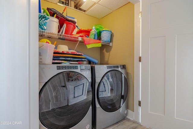 washroom featuring laundry area, washer and clothes dryer, and wood finished floors