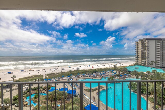 balcony with a water view and a beach view